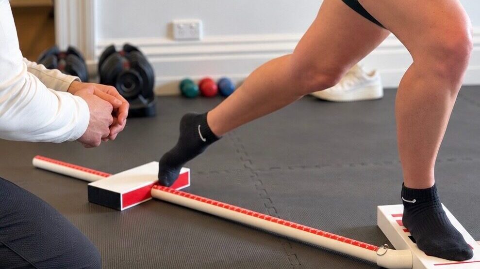 Physiotherapist assessing lower limb movement for shin pain in a runner at Rebuild Physio Glenelg